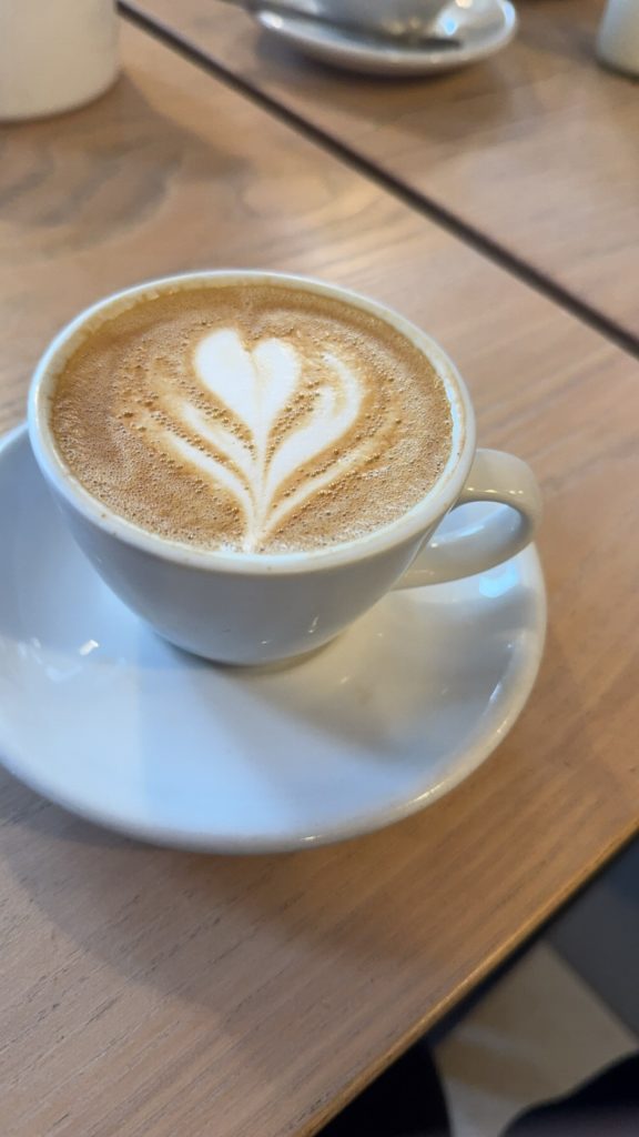 A cup off coffee in a white mug and on a white saucer.